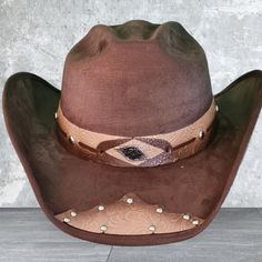 Add Some Western Flair To Your Wardrobe With This Cattleman Cowboy Hat Ranch Style. Made In Mexico With A Suede-Like Fabric, This Vintage Hat Features A Solid Pattern In Brown Color. The Hat Is Designed For Men And Has A Size Of M. It Is Perfect For Travel Occasions And Is Suitable For Those Who Love Western Or Cowboy Themes. The Cowboy Hat Has A Traditional Style With A Cowboy Or Ranchero Look That Will Make You Stand Out From The Crowd. It's A Great Accessory For A Western-Themed Party Or Even Western Brown Hat, One Size Fits Most, Brown Fedora For Rodeo Events, Western Brown Hat One Size Fits Most, Brown Country Cap Hat, Brown Western Hat One Size Fits Most, Brown Cap For Rodeo, Brown Country Cap Style Hat, Brown Country Style Felt Hat, Fitted Rustic Brown Hat