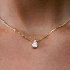 The ultimate timeless piece. A solitaire pear is centered between the collarbone on an 18k gold chain. The length of this necklace is 16" (40cm). Please get in touch if you would like a different chain length. Shape, color, and size of the diamond are fully customizable as well. Diamond Solitaire Pendant Necklace, Pear Shaped Diamond Pendant Necklace, Pear Shaped Jewelry, Pear Diamond Necklace Designs, Engagement Necklace Jewelry, Pear Shape Necklace, Pear Pendant Necklace, Pear Shaped Necklace, Pear Shape Diamond Necklace