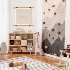 a child's playroom with climbing wall and wooden toys on the floor in front of it