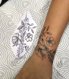 a woman's foot with a flower tattoo on it