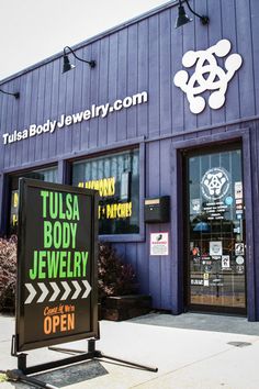 the front of a jewelry store with an open sign