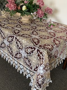 a table covered with lace and pink flowers