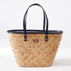 This structured tote, lined in coastal chic stripes, features a classic silhouette handcrafted from natural palm leaf. The leather handles and rim add strength to the lightweight design, perfect for a day about town or trip to the beach. Customize it with a classic monogram for a tote that's uniquely yours, or give to that special someone as a thoughtful gift.   About the artisan: This item is handmade by artisans in the Philippines. A woman-owned and operated organization, they are a member of Palm Leaf Tote Beach Bag With Leather Handles, Everyday Woven Palm Leaf Bag, Handwoven Brown Palm Leaf Beach Bag, Eco-friendly Palm Leaf Beach Bag With Leather Handles, Eco-friendly Palm Leaf Tote Beach Bag, Coastal Chic, Palm Leaves, Leather Handle, Cotton Linen