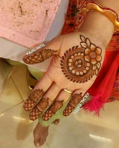 a woman's hand with henna tattoos on it