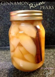 a jar filled with sliced apples sitting on top of a counter