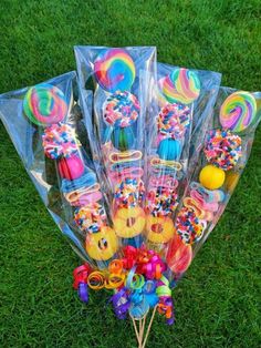 a bunch of lollipops and candy sticks on the grass