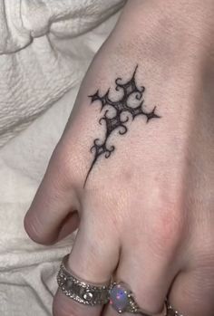 a woman's hand with a small tattoo on it