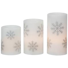 three frosted glass candle holders with snowflakes on the top and bottom,