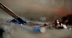 a close up of a pen and some water drops