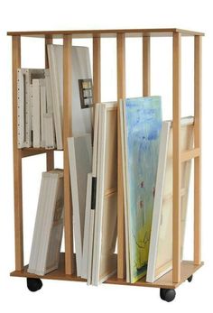 a wooden shelf with books and magazines on it's wheels, against a white background