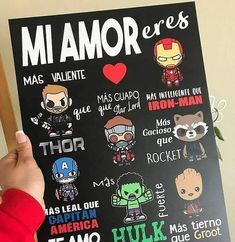 a person holding up a poster with some avengers stickers on it's back