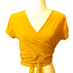 New With Tags. Cotton Candy V Neckline Wrap Cropped Yellow Mustard Knit Top Size Xl. Flattering And Comfortable , Pairing To Dress Up Or Dress Down . Approximate Measurements Laying Flat Pit To Pit 21” Waist 17” Length 19” Cheap Mustard V-neck Blouse, Yellow Stretch V-neck Top, Yellow Stretch V-neck Blouse, Trendy Gold V-neck Top, Chic Mustard Short Sleeve Top, Yellow Stretch Blouse For Day Out, Trendy Yellow Stretch Blouse, Gold Fitted Top For Day Out, Fitted Gold Top For Day Out