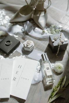 the table is covered with wedding accessories and personal items