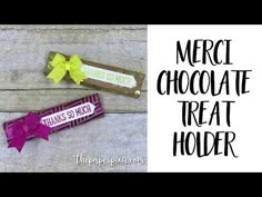 there are two candy bars with ribbons on them and the words merci chocolate treat holder