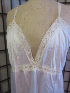 Here is a great woman's slip from the 1950's/60's by Deanna. It is a nylon knit with insert lace on the band and trimming the neckline and hem.. The straps are adjustable and it has a square cut back. The size is a 38, the cups measure 48 so probably a d size.  The length from center front is 30 inches. It is in great condition.  Great as lingerie or nightwear. What goes around, comes around Love of beauty and quality is happiness Shipping is standard mail which is not so slow in North America b Fitted Delicate Lace Nightgown For Sleep, Lace Trim Slip For Loungewear, Lace Trim Loungewear Slip, Lace Slip With Lace Trim For Loungewear, Bedtime Camisole Slip With Lace Trim, Bedtime Lace Trim Camisole Slip, White Fitted Sleepwear With Delicate Lace, White Fitted Lace Sleepwear, Fitted White Lace Sleepwear