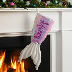 a christmas stocking hanging over a fireplace with the words merry new year on it