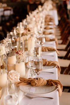 a long table is set up with candles and place settings for the guests to enjoy