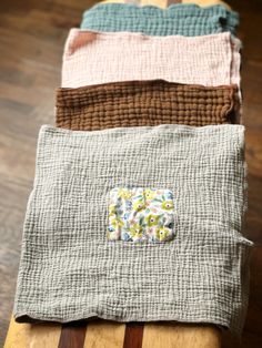 four pieces of cloth are stacked on top of each other in different colors and patterns