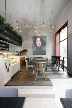 a dining room table with chairs and a painting on the wall