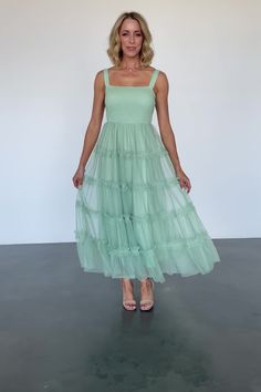 Dreamy tulle maxi for parties, photoshoots, and more Soft minty sage green Straight neckline Smocked bodice Tank strap sleeves Tulle maxi skirt with ruffled tiers Two layers of tulle for volume Skirt is fully lined Self and Lining: 100% Polyester Trina is 5'6, cup size 32D, size 2 and is wearing size S Volume Skirt, Tulle Maxi Dress, Light Sage Green, Tulle Maxi Skirt, Straight Neckline, Cup Size, Sage Green, Smocking, Maxi Skirt