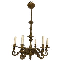 an antique chandelier with five candles