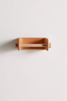 a wooden handle on a white wall