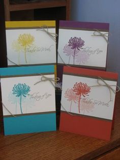 four cards with different colored flowers on them