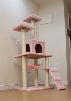 a pink cat tree in the corner of a room