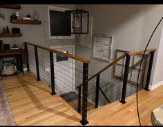 a living room filled with furniture and a tv on top of a wooden floor next to a wall