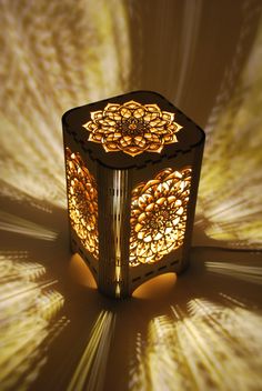 an intricately designed lamp is shown in the shadows