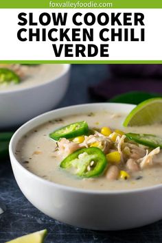 two bowls of slow cooker chicken chili with limes and jalapenos