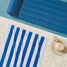 an overhead view of a towel and hat next to a pool