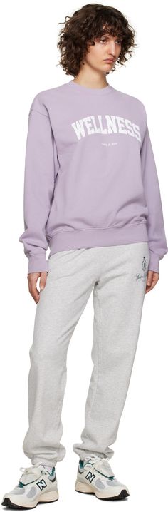 Pre-shrunk cotton fleece sweatshirt. · Rib knit crewneck, hem, and cuffs · Text and logo printed at front Supplier color: Faded lilac/White