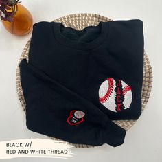 Stay warm in style with our custom embroidered sweatshirt for baseball enthusiasts! Whether you're cheering on your favorite team or simply want a cozy and personalized wardrobe staple, this embroidered sweatshirt is perfect for baseball moms, dads, or anyone who loves the sport. With a variety of options for personalization, this sweatshirt makes for a thoughtful and unique gift for all the baseball lovers in your life. Upgrade your game day outfit with our embroidered baseball sweatshirt and s Game Day T-shirt With Embroidered Logo, Varsity Style Top With Embroidered Graphics For Fan Gear, Black Tops With Ribbed Cuffs For Game Day, Fan Apparel Sweatshirt With Embroidered Logo And Crew Neck, Fan Apparel Sweatshirt With Embroidered Logo, Fan Apparel Crew Neck Sweatshirt With Embroidered Logo, Collegiate Embroidered Top For Game Day, Varsity Top With Embroidered Logo For Sports Events, Black School Spirit Sweatshirt For Sports