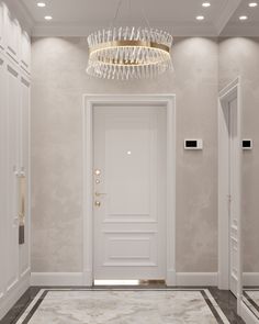 a white door with a chandelier hanging from it's side in an empty room