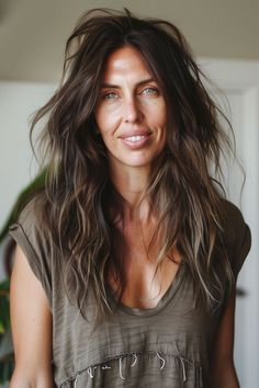 Woman with a tousled shag haircut, showcasing a heavily layered, carefree look. Shag Cut, Shoulder Length Layered