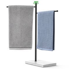 two towels are hanging on a towel rack next to a white square and black stand