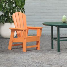 an orange and green chair sitting next to a table