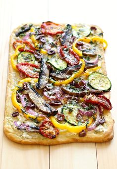 a flat bread pizza topped with vegetables and cheese