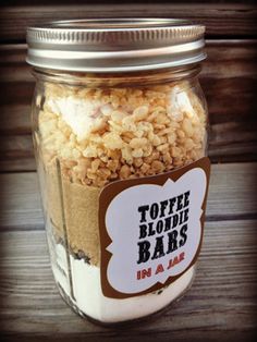 a jar filled with lots of food on top of a wooden table