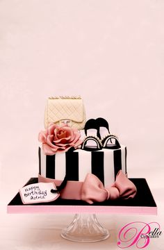 a pink and black striped cake with flowers on top is featured in an instagram