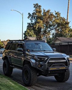 a black toyota truck parked on the side of the road