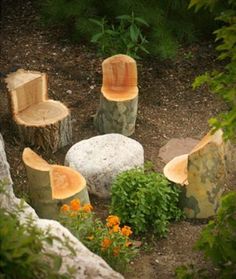 there are several chairs made out of tree stumps in the garden with flowers around them