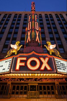 the fox theater marquee at night in front of a tall building with lights on it