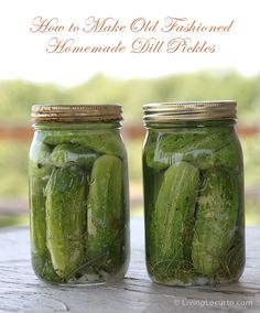 two jars filled with pickles sitting on top of a wooden table