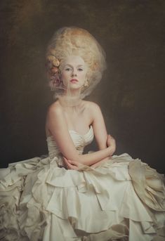 a woman in a white dress with flowers on her head