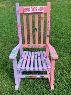 a child's wooden rocking chair with personalized letters on the back and sides