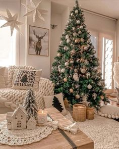 a living room with a christmas tree in the corner and decorations on the coffee table