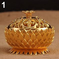 a golden perfume bottle sitting on top of a table