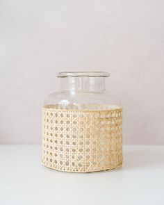 a glass jar with a lid is sitting on a table